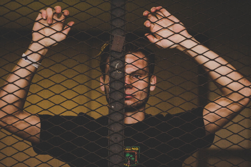 arcade game machine, person, young adult, real people, dungeon, leisure activity, fence, young women, scoreboard, s, day, prison, hairstyle, body part