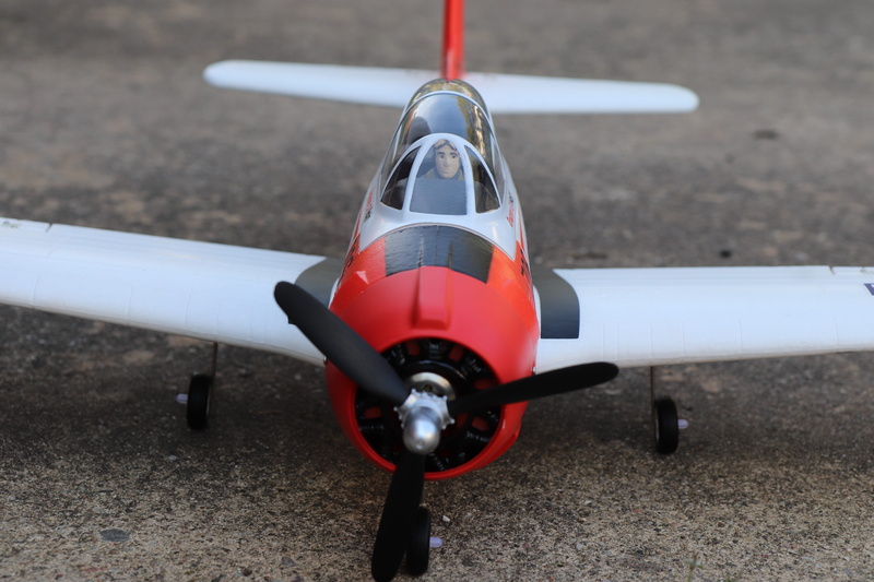 outdoors, focus on foreground, wing, nature, red, speed, mode of transportation, model construction, flyer, airport runway, stationary, single object, airport