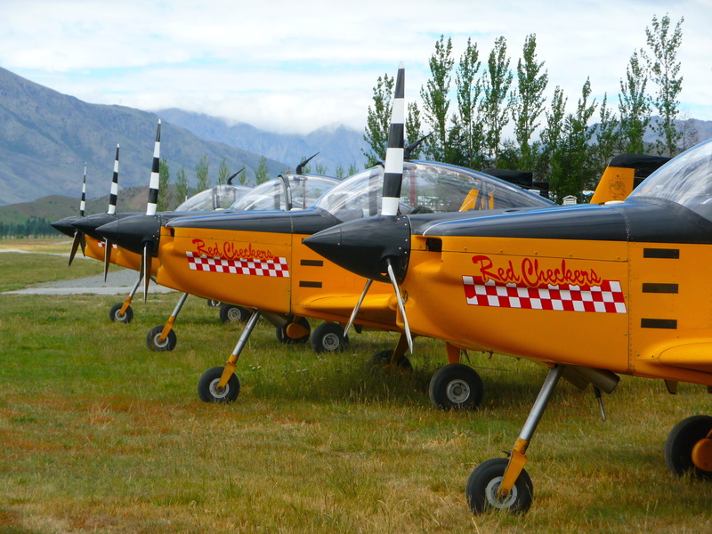 sky, mode of transportation, travel, yellow, airplanes, airshow, environment, aircraft, land, tree, land vehicle, aeroplane, stationary, outdoors, air vehicle