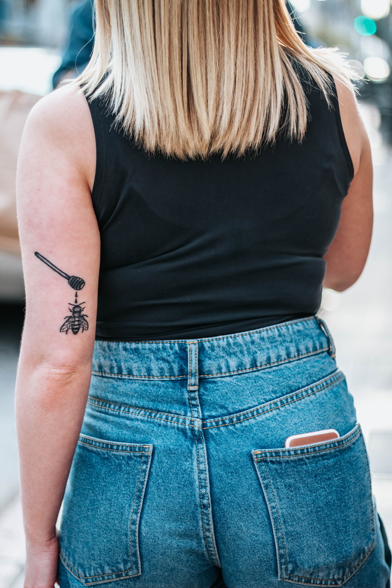 denim, bumblebee, adult, lifestyles, blonde, real people, woman, los angeles, casual clothing, hand, midsection, ink, honey, united states, rear view, hair