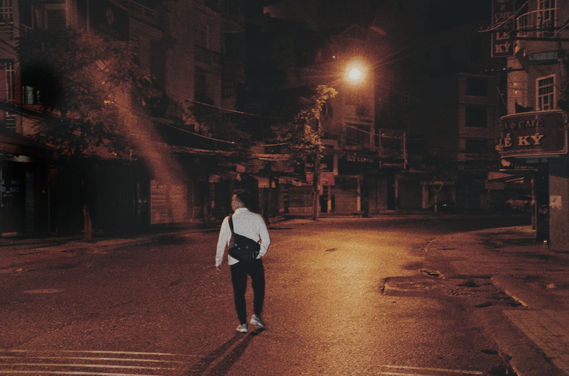outdoors, road, city, real people, building exterior, alone, built structure, architecture, walking, direction, alley, illuminated, building, urban, footpath
