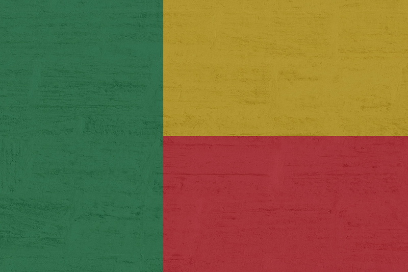 green color, flag, textured, day, orange color, built structure, yellow, concrete, paint, benin, full frame, wall - building feature, no people, pink color