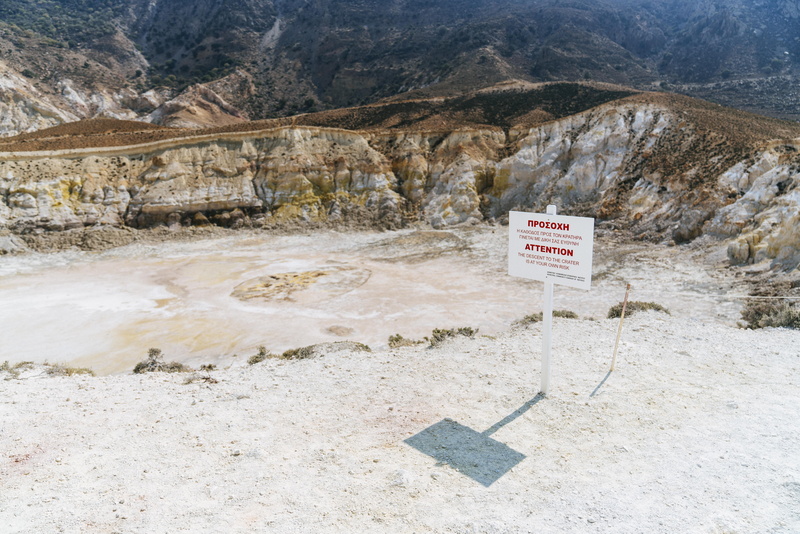 mountain, building, beauty in nature, outdoors, text, mountain range, environment, 8K, day, peak, wilderness, volcanic, dirt road, non-urban scene, signage