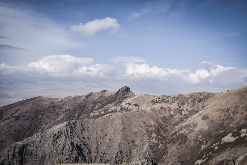 panoramic, mountain range, field, non-urban scene, plateau, land, remote, cloud - sky, tranquility, dirt road, no people, day, countryside, environment