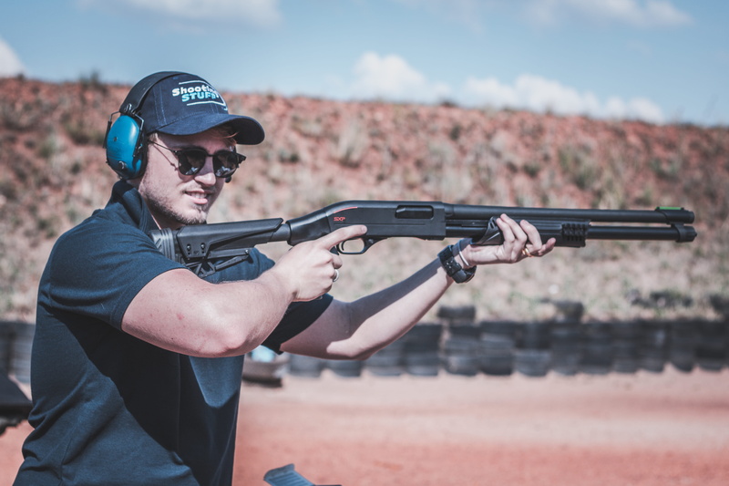 facial expression, shades, real people, aiming, focus, offense, shooting a weapon, headwear, one person, depth of field, target shooting, firearm, bullets