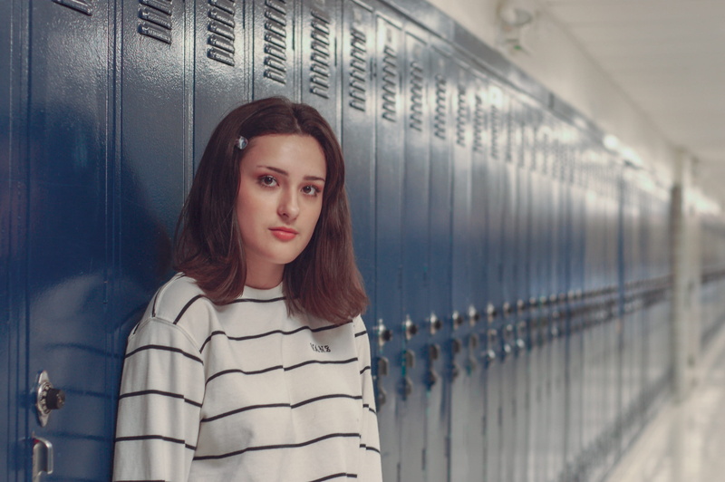 neck, casual clothing, looking at camera, clothing, contemplation, beautiful woman, bracket, overcoat, school, human, locker, hair, one person, sleeve