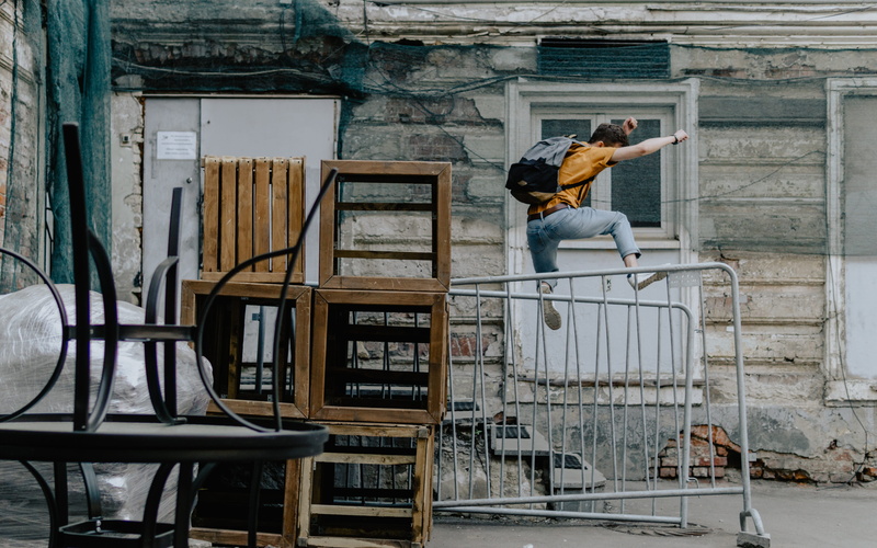 person, pants, occupation, fly, near, adult, young adult, jump, one person, apparel, lifestyles, apple box, architecture, ladder, metal, jumping, real people