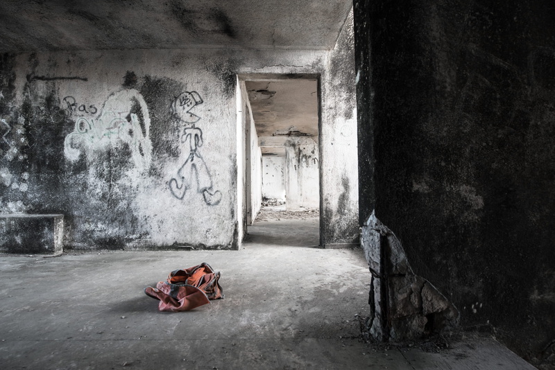furniture, social issues, brown, graffiti, floor, cloth, corridor, one person, obsolete, relaxation, indoors, messy, abandon, architecture, construction