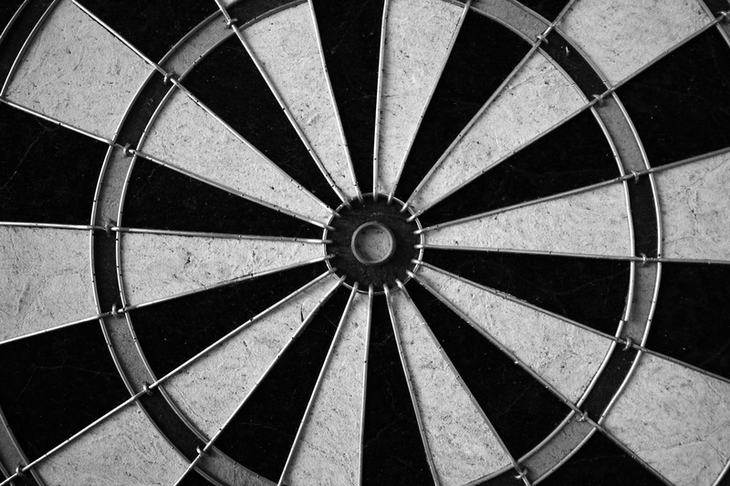 leisure activity, day, shape, accuracy, dartboard, black-and-white, darts, sunlight, concentric, no people, pattern, circle, sport, sports target, wall - building feature