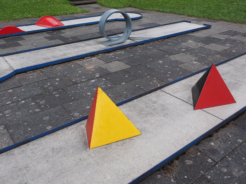 yellow, pyramids, road, high angle view, red, minigolf ground, precision sport, paving stone, eternit track, park - man made space, flag, skill game, miniature golf