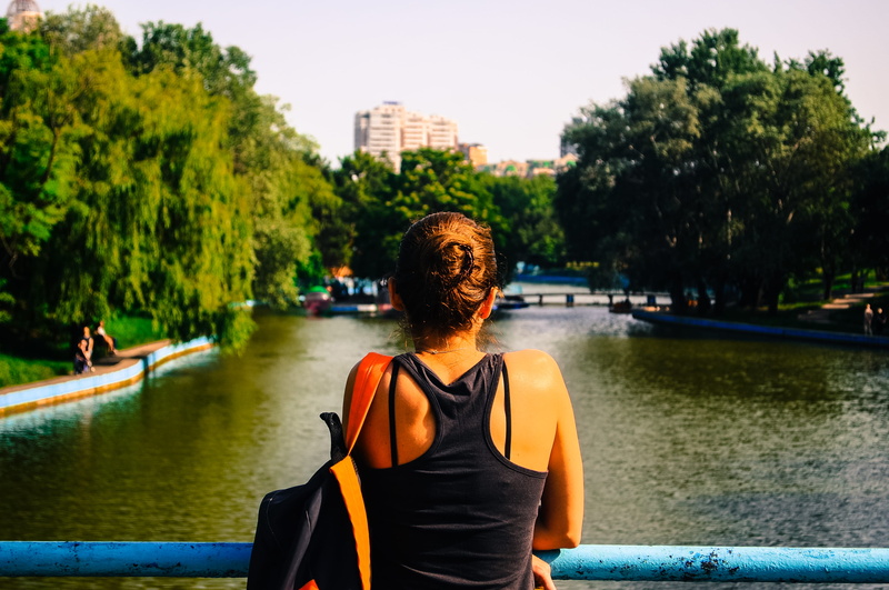 water, tree, waist up, outdoors, nature, plant, architecture, facing, lifestyles, body, one person, woman, 2K, person, front view, transportation, racerback