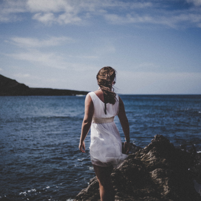 seashore, fashion, stones, horizon over water, leisure activity, hairstyle, sun, real people, girl, casual clothing, young adult, water, rocks, white dress