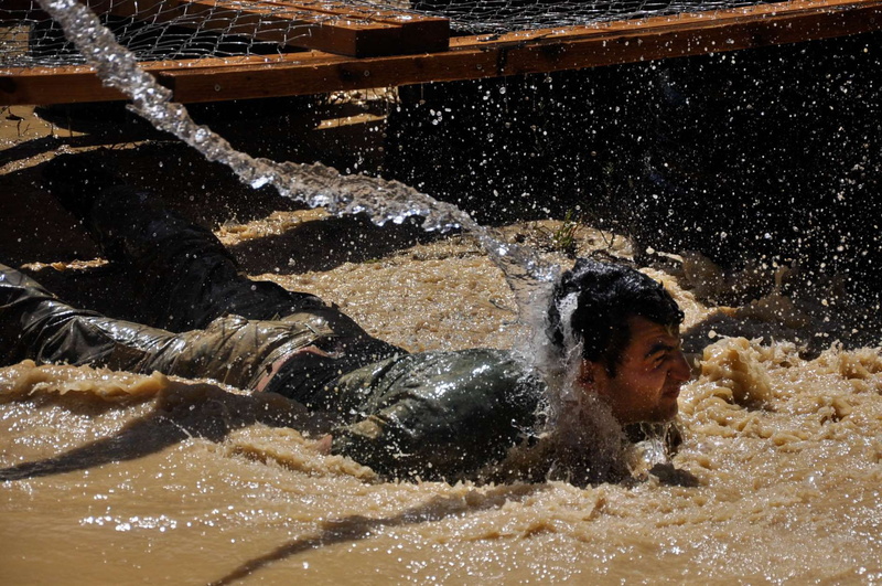 run, leisure activity, shirtless, swimming, outdoors, legion, mud, lifestyles, motion, splashing, obstacle, real people, nature, sport, parcours, headshot