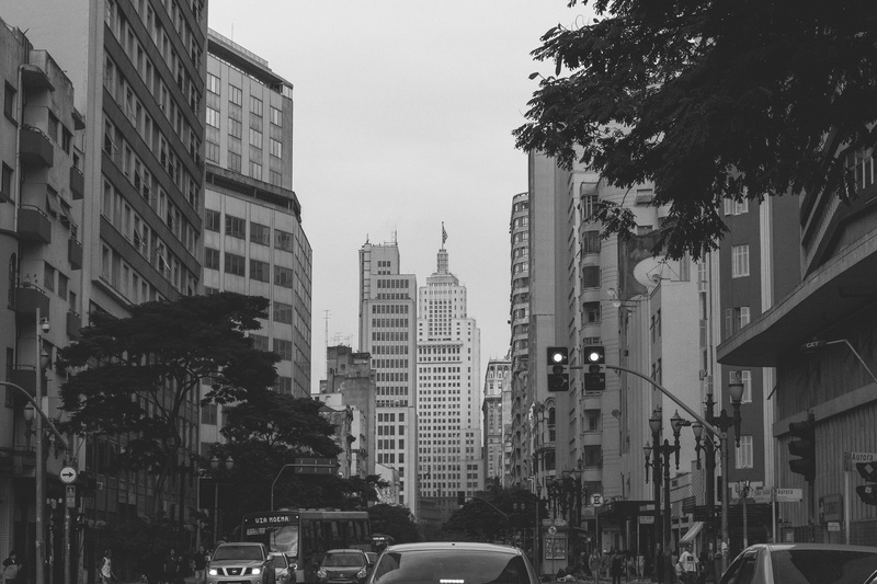 outdoors, skyscraper, city street, vehicles, tower, building, car, mode of transportation, motor vehicle, street, buildings, transportation system, modern