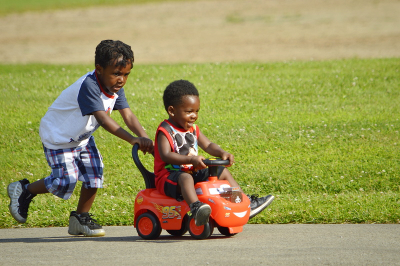 brown, emotion, pavement, green, innocence, two people, casual clothing, driving, children, males, athletic, child, sneakers, brown-skinned, togetherness
