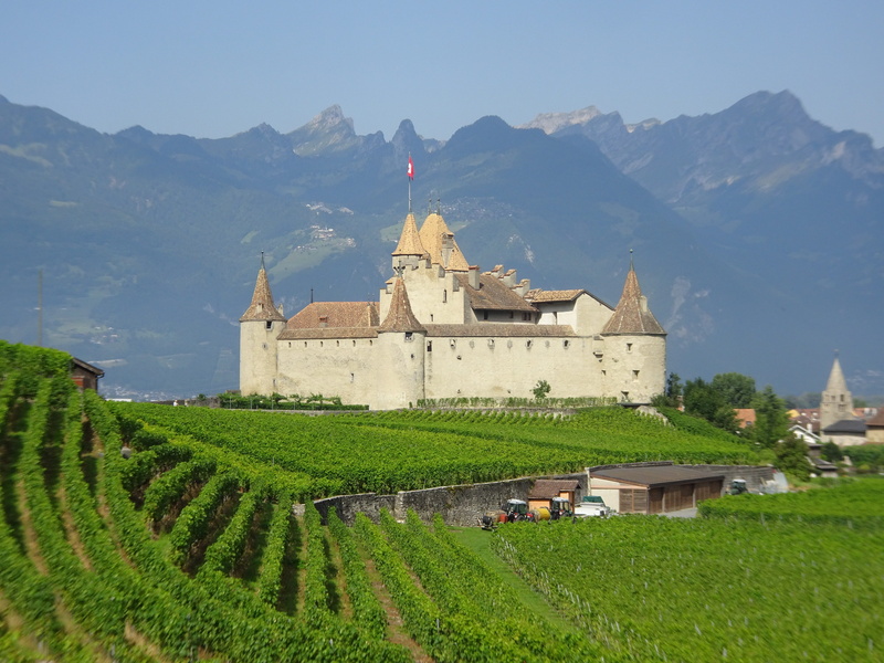 belief, green color, mountains, built structure, grass, tower, medieval, spirituality, building exterior, travel, field, tourism, majestic, place of worship