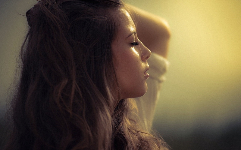 leisure activity, simple background, face, depression - sadness, contemplation, women outdoors, hair, young adult, human hair, profile, brunette, side view