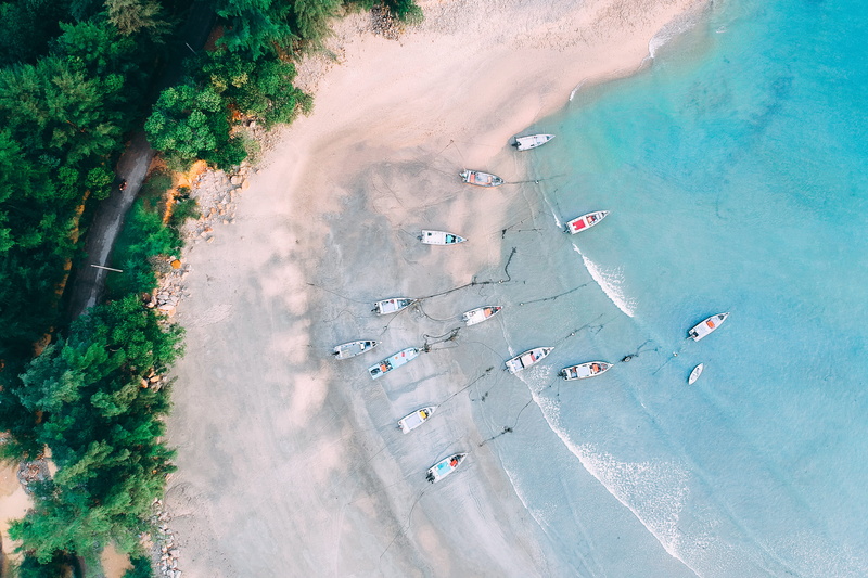 birds eye view, sea, environment, island, scenic, mode of transportation, shore, surrounded, land, watercrafts, sunlight, seashore, aerial view, waves