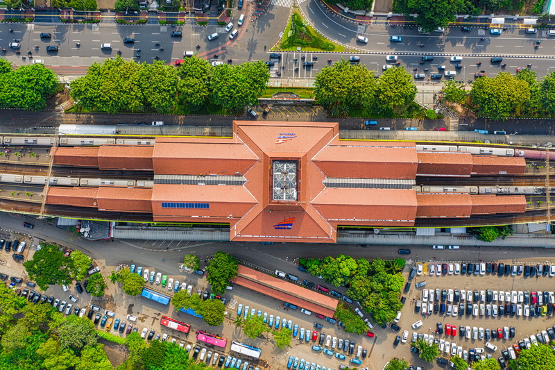 railway station, plant, streets, high angle view, daylight, transportation, large group of people, green, trees, roofs, tree, scenery, drone shot, street
