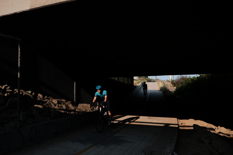 sun, one person, biker, adult, human, outdoors, motion, sports, biccyle, activity, way, real people, night, street, san diego, man, full length, architecture
