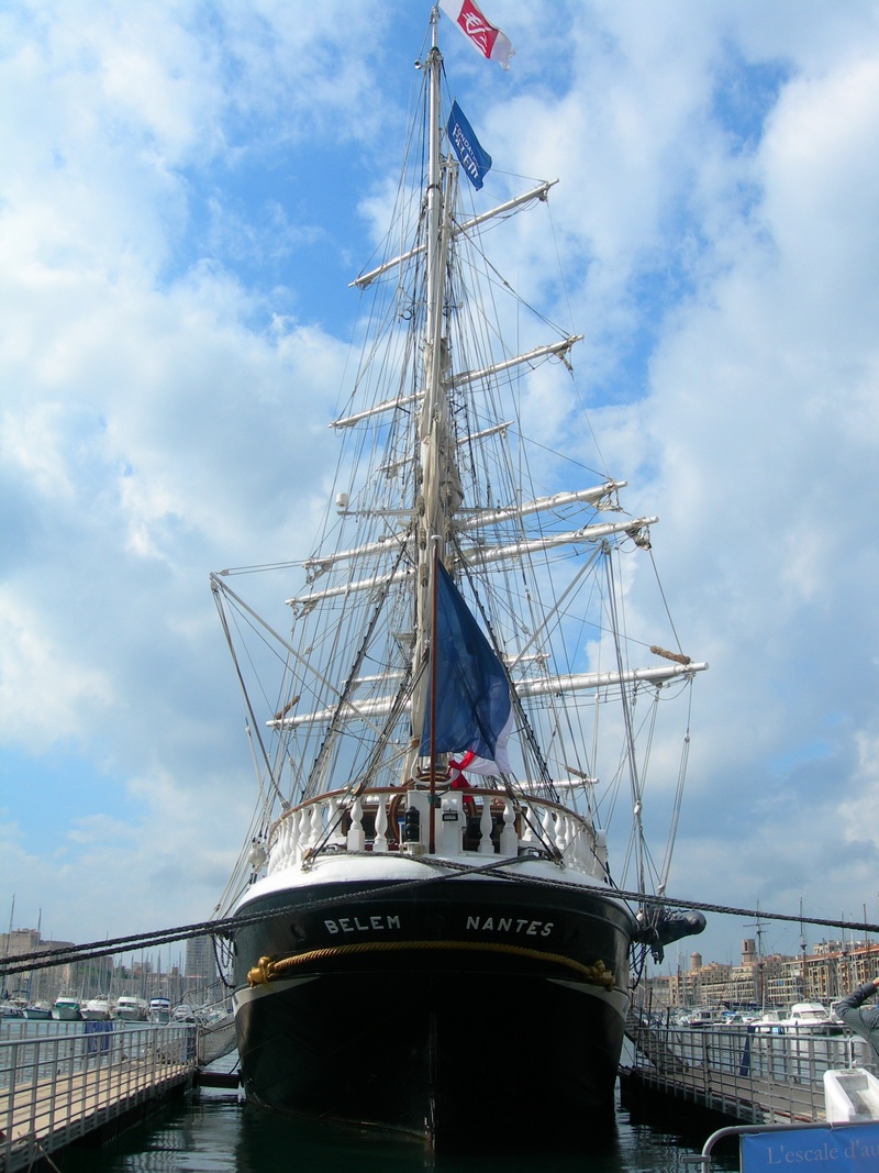 blue sky, built structure, white clouds, day, schooner, navigation, ship, water, landscape, a historical monument, mode of transportation, cabotage, nautical vessel
