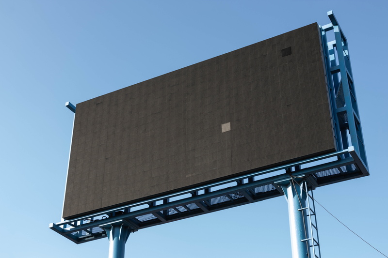copy space, outdoors, nature, billboard, business, built structure, blue, architecture, text, no people, turned, signage, marketing, low angle view, communication
