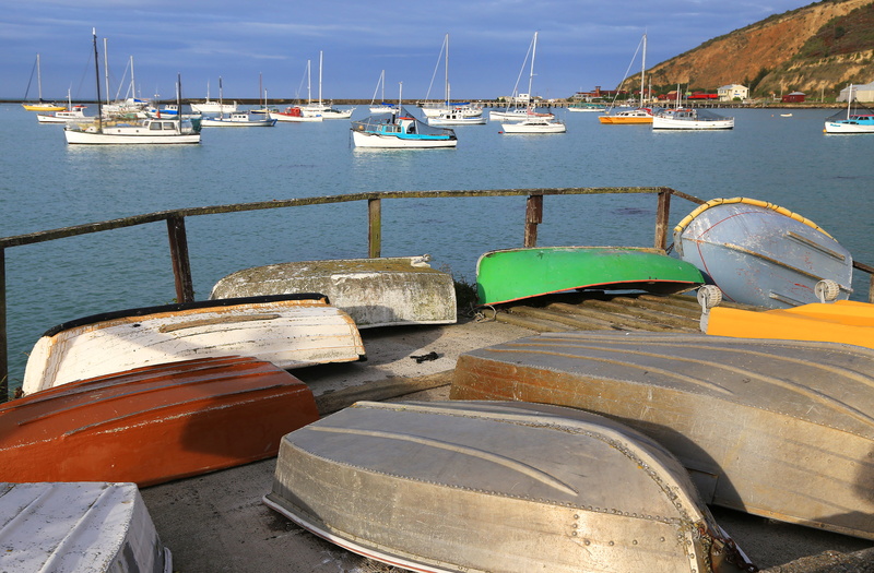 fishing boat, wooden fence, no people, blue, harbor, jetty, nautical vessel, boats, fishing industry, sailboat, sea, pier, outdoors, nautical, sky, dinghies