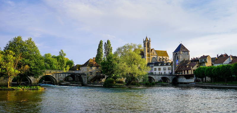 architecture, travel destinations, sky, landscape, tree, river, building exterior, arch bridge, bridge, built structure, plant, scenic, outdoors, city