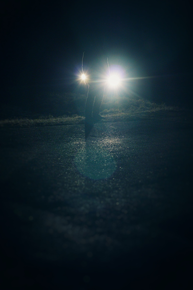 outdoors, glowing, silhouette, street, unrecognizable person, sky, mystery, dark, lights, light - natural phenomenon, one person, headlights, person, light