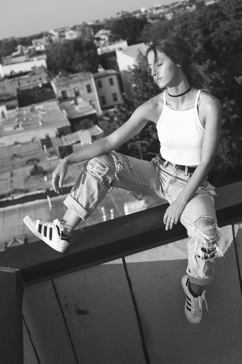 building exterior, beauty, woman, united states, full length, rooftop, brooklyn, thinking, women, fashion, sitting, looking, urban, front view, casual clothing