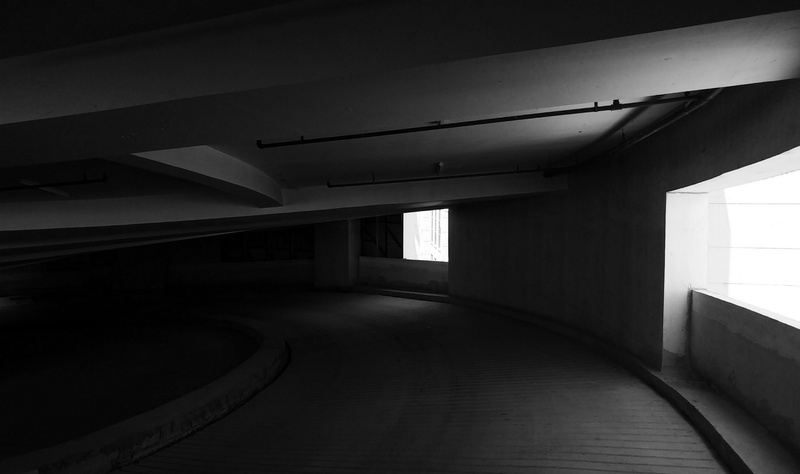 dark, built structure, ramp, underpass, parking lot, empty, construction, architecture, indoors, architectural column, ceiling, railing, absence