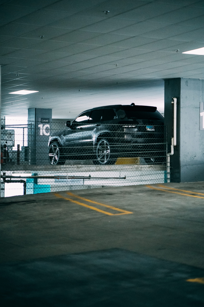 black car, day, rims, built structure, black, parked car, architectural column, car, underpass, land vehicle, tunnel, wall - building feature, transportation system