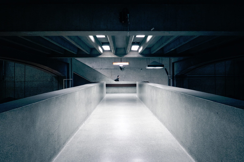wall - building feature, architecture, parking garage, guy, underpass, built structure, man, the way forward, ceiling, direction, illuminated, urban, parking lot