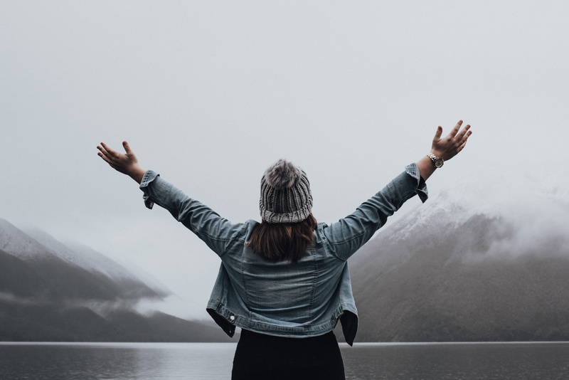 young, standing, mist, outdoor, nature, arms stretched out, mountain, body part, women, human limb, beanie, explorer, lady, one person, winter, emotion