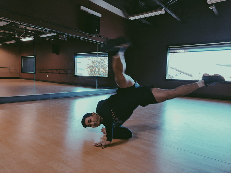 leisure activity, screen, men, stretch, flooring, flexibility, dance pose, one person, sport, healthy lifestyle, real people, dance, sports clothing, breakdance