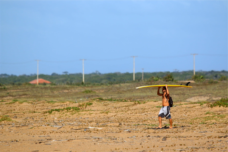 real people, board, rural scene, one woman only, walkding, surfer, leisure activity, head, sand, one young woman only, beach, nature, young adult, yellow