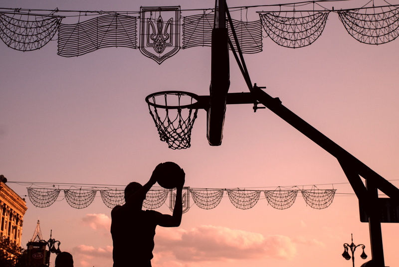 people, leisure activity, sport, three quarter length, adult, building exterior, sky, nature, low angle view, men, lifestyles, streetball, sunset, outdoors