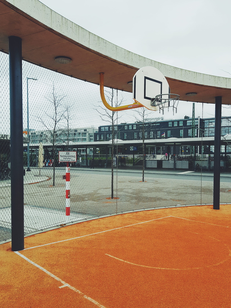 barrier, streetball, sunlight, tennis, street, sky, winter, city, nature, playing field, boundary, architecture, outdoors, urban, building exterior, sport