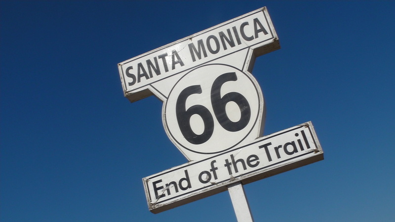 road, clear sky, road sign, day, santa monica, outdoors, sky, route 66, close-up, sign, number, directional sign, economy, blue, western script, guidance