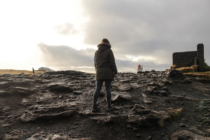 rear view, solid, fashion, land, rock - object, ground, adult, people, one woman only, warm clothing, outdoors, daytime, lifestyles, real people, rock