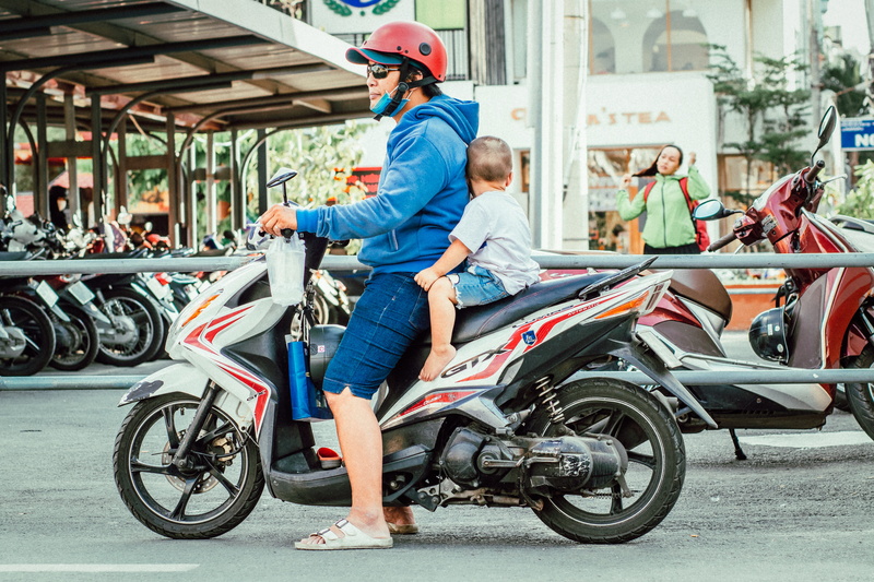 man, mid adult, casual clothing, road, motorbike, street, day, males, city, adult, people, outdoors, full length, child, vehicle, architecture, dad, boy