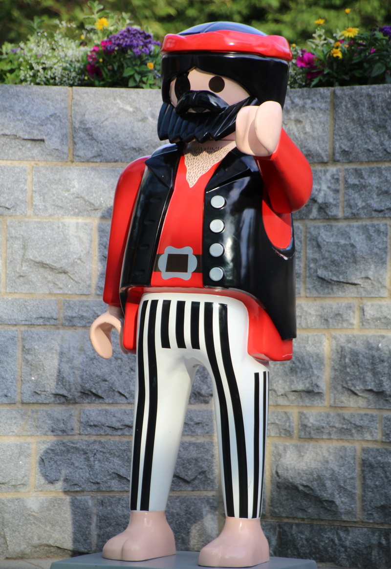 standing, unrecognizable person, Toys, leisure activity, clothing, human body part, stage costume, lifestyles, security, wall - building feature, black color