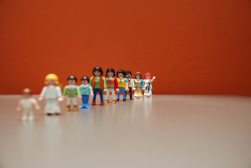 row, table, teamwork, childhood, red, indoors, figurine, males, group of people, side by side, sitting, men, waving, learning, playmobil, females, people