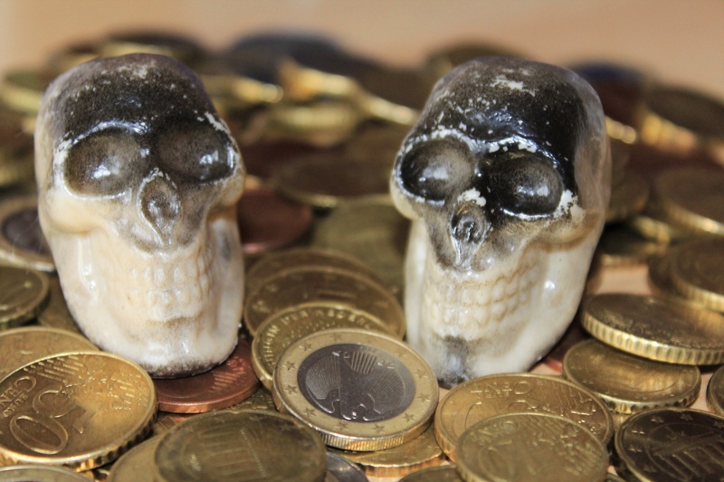 food, choice, coins, skull and crossbones, group of objects, large group of objects, coin, abundance, table, animal wildlife, no people, selective focus