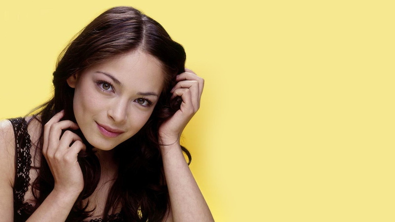 yellow, one person, face, looking at camera, long hair, yellow background, copy space, smiling, hand, contemplation, beautiful woman, celebrity, young women