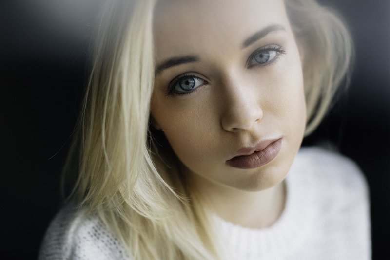 headshot, blond hair, emotion, beautiful woman, depression - sadness, adult, blue eyes, contemplation, sadness, black background, human face, young adult