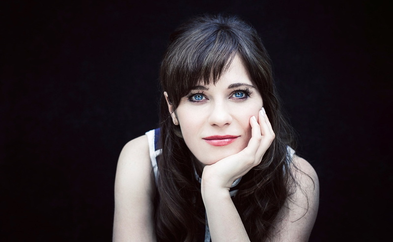 one person, beauty, bangs, zooey deschanel, beautiful woman, studio shot, black background, front view, portrait, fashion, contemplation, indoors, uncertainty
