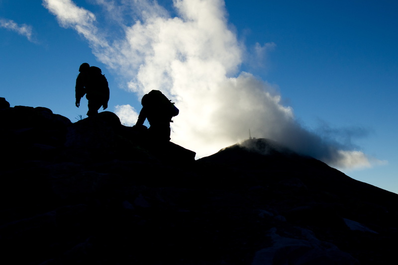 two, mountain peak, blue, real people, gaustatoppen, standing, mountain, beauty in nature, ascent, non-urban scene, rock, hiking, day, cloud - sky, leisure activity