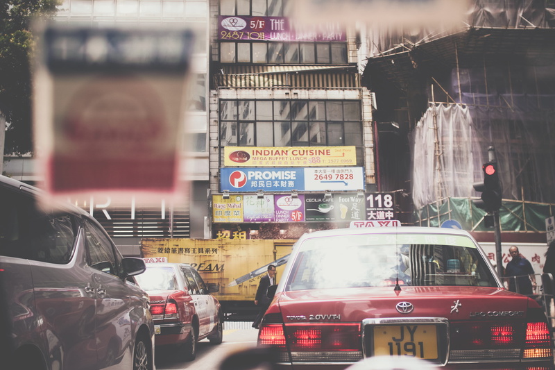 communication, motor vehicle, daytime, car, road, building exterior, mode of transportation, city street, downtown, text, land vehicle, hongkong, bulletin
