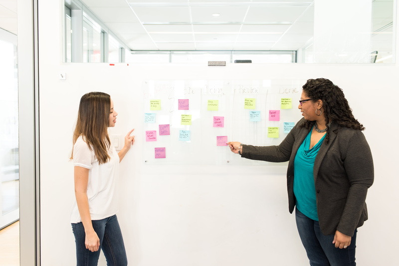 three quarter length, notes, indoors, office, teamwork, cooperation, side view, conversation, sticky notes, strategy, businesswoman, adult, planning, business